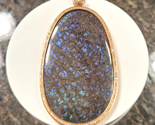 DIY Jewellery Custom 18K Gold Made Double-sided red colour Ammolite set into an18K gold swiveling pendant setting accented with diamonds all around